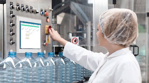 A woman at plastic bottle filling production line